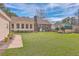 Expansive backyard with a lush lawn, brick house, and storage shed at 634 Lakeside Dr, Moncks Corner, SC 29461