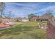 Expansive backyard showcasing green lawn, detached garage, patio with seating and mature landscaping at 634 Lakeside Dr, Moncks Corner, SC 29461