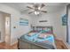 Comfortable bedroom with ceiling fan, wood flooring, and nautical-themed bedding at 634 Lakeside Dr, Moncks Corner, SC 29461