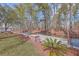 Scenic waterfront featuring a wooden dock, mature trees, and landscaping for outdoor enjoyment at 634 Lakeside Dr, Moncks Corner, SC 29461