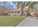 Charming home featuring a welcoming front porch, well-maintained lawn, and a gravel driveway at 634 Lakeside Dr, Moncks Corner, SC 29461