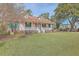 Inviting one-story home with a welcoming front porch, shuttered windows, and lush green lawn at 634 Lakeside Dr, Moncks Corner, SC 29461