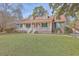 Charming one-story home featuring a cozy front porch, dormer windows, and a well-manicured lawn at 634 Lakeside Dr, Moncks Corner, SC 29461