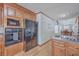 Kitchen featuring wood cabinets, oven, refrigerator, and wood floors at 634 Lakeside Dr, Moncks Corner, SC 29461