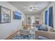 Cozy living room featuring hardwood floors, a comfortable sofa and large movie poster at 634 Lakeside Dr, Moncks Corner, SC 29461