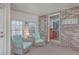 Relaxing sun room with brick accents, comfortable seating and ample natural light at 634 Lakeside Dr, Moncks Corner, SC 29461
