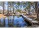 Picturesque waterfront scene with a well-maintained dock, mature trees, and views of the property at 634 Lakeside Dr, Moncks Corner, SC 29461