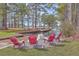 Waterfront view with Adirondack chairs, firepit, and lakeside access at 634 Lakeside Dr, Moncks Corner, SC 29461