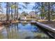 Wide angle waterfront shot of the house, detached garage and boat dock showing water access at 634 Lakeside Dr, Moncks Corner, SC 29461