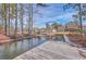 Waterfront view of the house and detached garage with an inviting dock for enjoying the water views at 634 Lakeside Dr, Moncks Corner, SC 29461