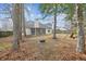 Spacious backyard featuring mature trees, fire pit, and a screened porch for relaxing and entertaining outdoors at 8153 Governors Walk, North Charleston, SC 29418