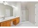 Bathroom featuring a double sink vanity with a makeup table and a glass enclosed shower at 8153 Governors Walk, North Charleston, SC 29418