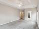 Carpeted bedroom featuring trey ceiling, ceiling fan and two doorways to bath and closet at 8153 Governors Walk, North Charleston, SC 29418