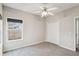 Neutral-toned bedroom with a ceiling fan, closet, and a view from two windows at 8153 Governors Walk, North Charleston, SC 29418
