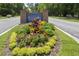 A beautifully landscaped community entrance sign with colorful flowers and manicured greenery at 8153 Governors Walk, North Charleston, SC 29418