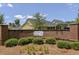 Welcoming entrance to The Oaks at Indigo featuring a brick wall and lush landscaping, offering a serene community setting at 8153 Governors Walk, North Charleston, SC 29418