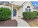 Inviting entrance with a decorative door, white pillars, and manicured greenery at 8153 Governors Walk, North Charleston, SC 29418