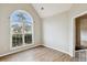 Bright living room featuring a vaulted ceiling and a large window overlooking the well manicured front yard at 8153 Governors Walk, North Charleston, SC 29418