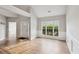 Bright and airy living area with wood floors, large window, and wainscoting details at 8153 Governors Walk, North Charleston, SC 29418