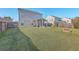 Lush backyard featuring a well-maintained lawn, inviting fire pit, and a charming screened porch at 100 Hunters Wood Dr, Summerville, SC 29485