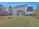 Spacious backyard with green lawn, screened porch, and brick fire pit, perfect for outdoor enjoyment at 100 Hunters Wood Dr, Summerville, SC 29485