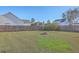 Expansive backyard with a brick fire pit and well-manicured lawn, perfect for outdoor gatherings and relaxation at 100 Hunters Wood Dr, Summerville, SC 29485