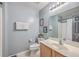 Cozy bathroom with grey walls, a wood vanity, white toilet, and framed art on the walls at 100 Hunters Wood Dr, Summerville, SC 29485