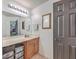 Well-lit bathroom features a vanity with drawers and doors and a dark door to another room at 100 Hunters Wood Dr, Summerville, SC 29485