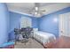 Compact bedroom with blue walls, neutral carpet, fan, desk, and lots of natural light at 100 Hunters Wood Dr, Summerville, SC 29485