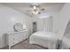 Bright bedroom with ceiling fan, plush carpet, dresser, mirror and bright natural lighting at 100 Hunters Wood Dr, Summerville, SC 29485