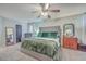 Spacious Primary bedroom with large bed, seating area, ceiling fan and natural light at 100 Hunters Wood Dr, Summerville, SC 29485