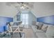 Cozy bonus room featuring plush couches, natural light, and an exercise bike, perfect for relaxation and fitness at 100 Hunters Wood Dr, Summerville, SC 29485