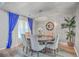 Elegant dining room featuring a round table, chandelier, and blue curtains, perfect for Gathering gatherings at 100 Hunters Wood Dr, Summerville, SC 29485