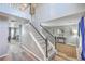 Bright foyer with wood flooring, staircase with white railings, and views of the adjacent living areas at 100 Hunters Wood Dr, Summerville, SC 29485