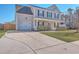Charming two-story home with a well-manicured lawn, inviting front porch, and attached garage, offering curb appeal at 100 Hunters Wood Dr, Summerville, SC 29485