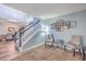 Inviting foyer with a staircase, decorative artwork, cozy chairs, and a view into the dining area at 100 Hunters Wood Dr, Summerville, SC 29485