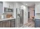 Well-lit kitchen with stainless steel appliances, wooden cabinets, and marble countertops at 100 Hunters Wood Dr, Summerville, SC 29485