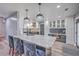 Modern kitchen with granite counters, stainless steel appliances, crystal chandeliers, and a breakfast bar at 100 Hunters Wood Dr, Summerville, SC 29485