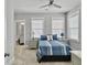 Sun-filled bedroom with a ceiling fan, two windows and ensuite bathroom access at 1020 Lyle Way, Mount Pleasant, SC 29466