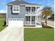 Two story home with garage, double porch, lawn and paved drive at 1020 Lyle Way, Mount Pleasant, SC 29466