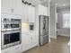 Kitchen with white cabinets, stainless steel appliances including a double oven, and light hardwood flooring at 1020 Lyle Way, Mount Pleasant, SC 29466