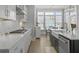 Light and bright kitchen showcasing white cabinets, stainless steel appliances, and a breakfast bar with chairs at 1020 Lyle Way, Mount Pleasant, SC 29466