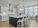 Bright kitchen with white countertops, a dark blue kitchen island, and modern pendant lighting at 1020 Lyle Way, Mount Pleasant, SC 29466