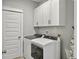 Convenient laundry room with modern washer and dryer and ample cabinet space at 1020 Lyle Way, Mount Pleasant, SC 29466