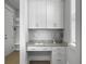 Cozy office nook featuring white cabinetry, granite countertops, and natural light from the window at 1020 Lyle Way, Mount Pleasant, SC 29466