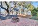 Inviting backyard features a brick patio with a fire pit and mature trees for shade and relaxation at 1048 Wharf Indigo Pl, Mount Pleasant, SC 29464