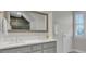 Bathroom with double vanity, large mirror, and plenty of natural light at 1048 Wharf Indigo Pl, Mount Pleasant, SC 29464