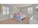Well-lit bedroom featuring neutral tones, plush carpet, and double shuttered windows at 1048 Wharf Indigo Pl, Mount Pleasant, SC 29464