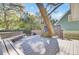 Outdoor wooden deck featuring built-in seating surrounding a mature tree at 1048 Wharf Indigo Pl, Mount Pleasant, SC 29464