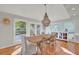 Elegant dining room featuring a large wooden table, stylish lighting, and ample natural light at 1048 Wharf Indigo Pl, Mount Pleasant, SC 29464
